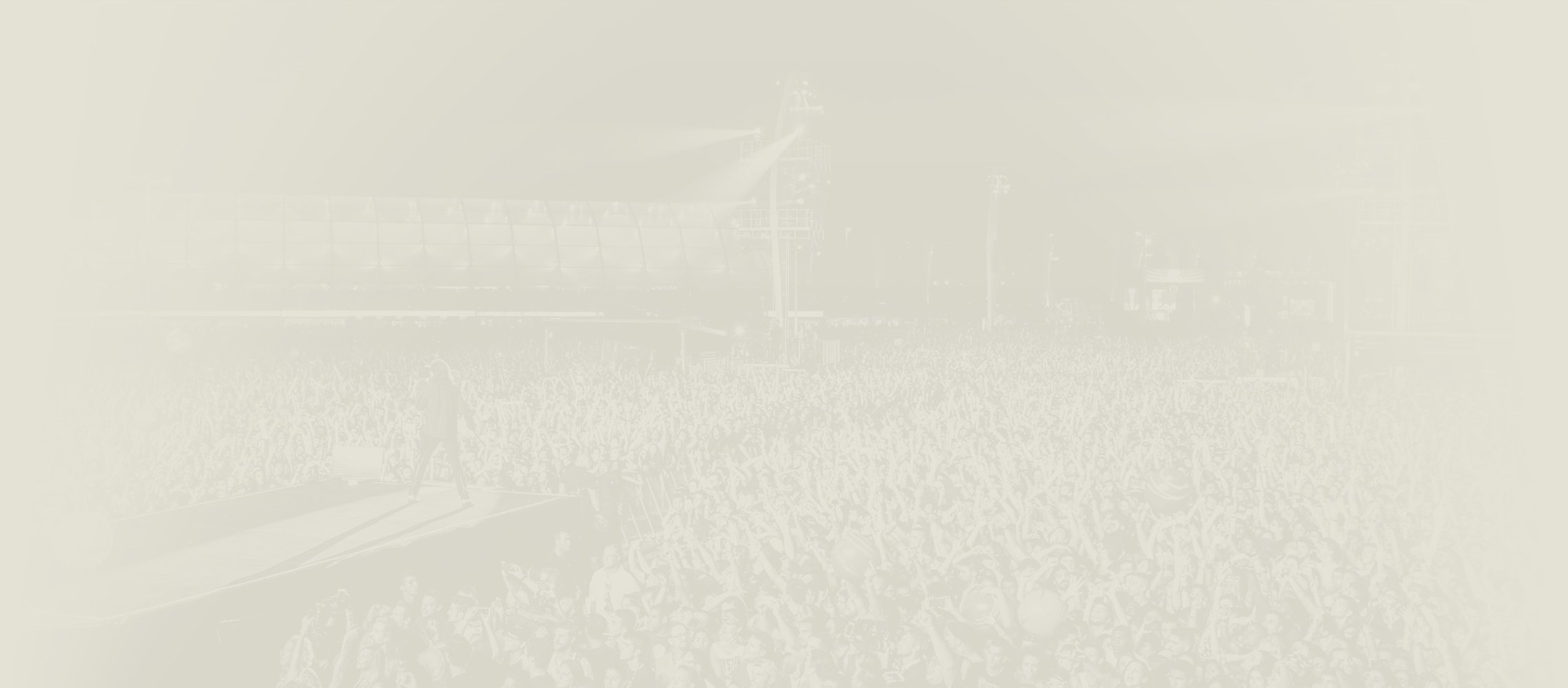 Background image showing a big crowd in front of stage