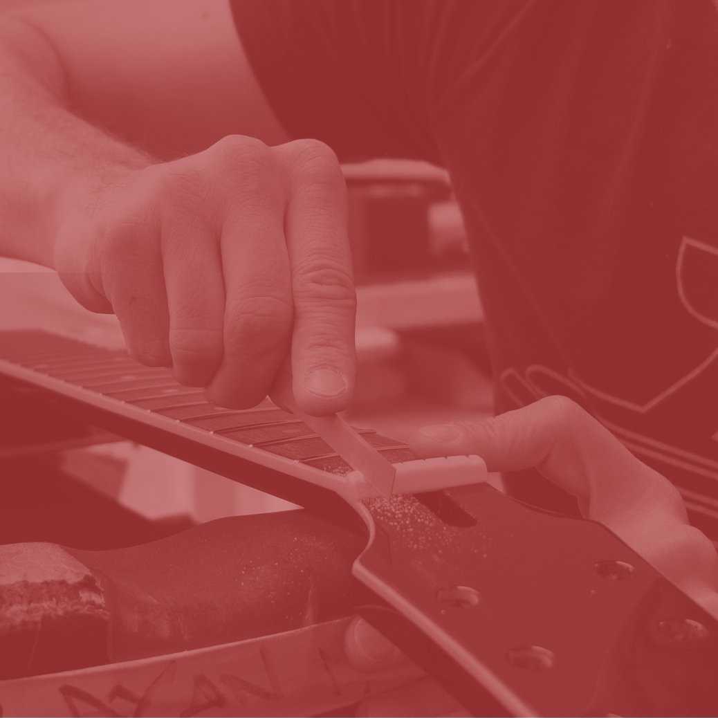 Photo of a Duesenberg Luthier cutting a nut